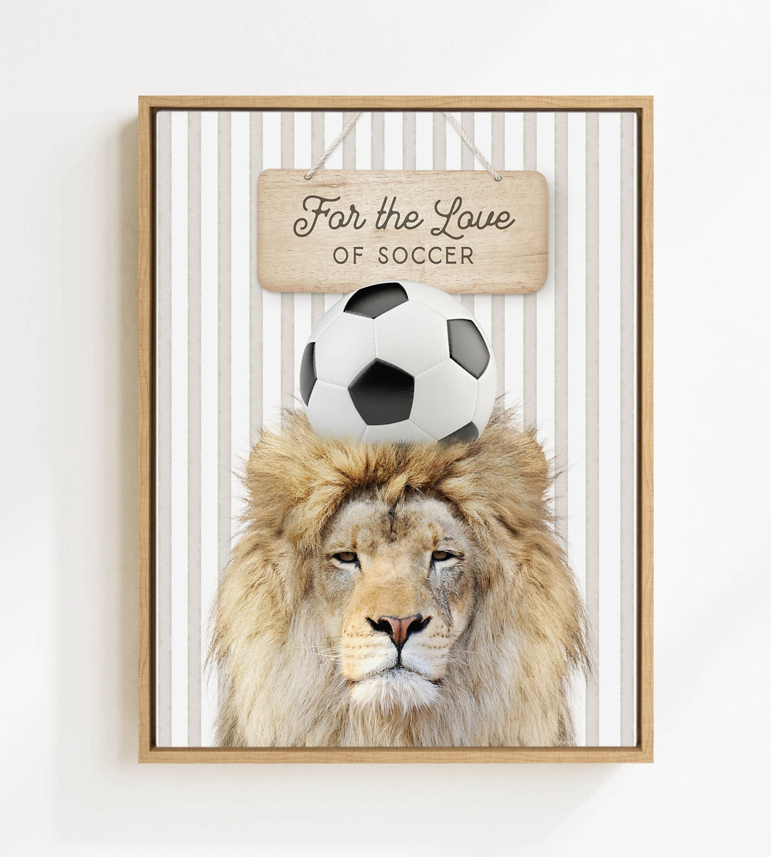 A framed image of a lion with a soccer ball on its head, accompanied by a wooden sign that reads "For the Love of Soccer".