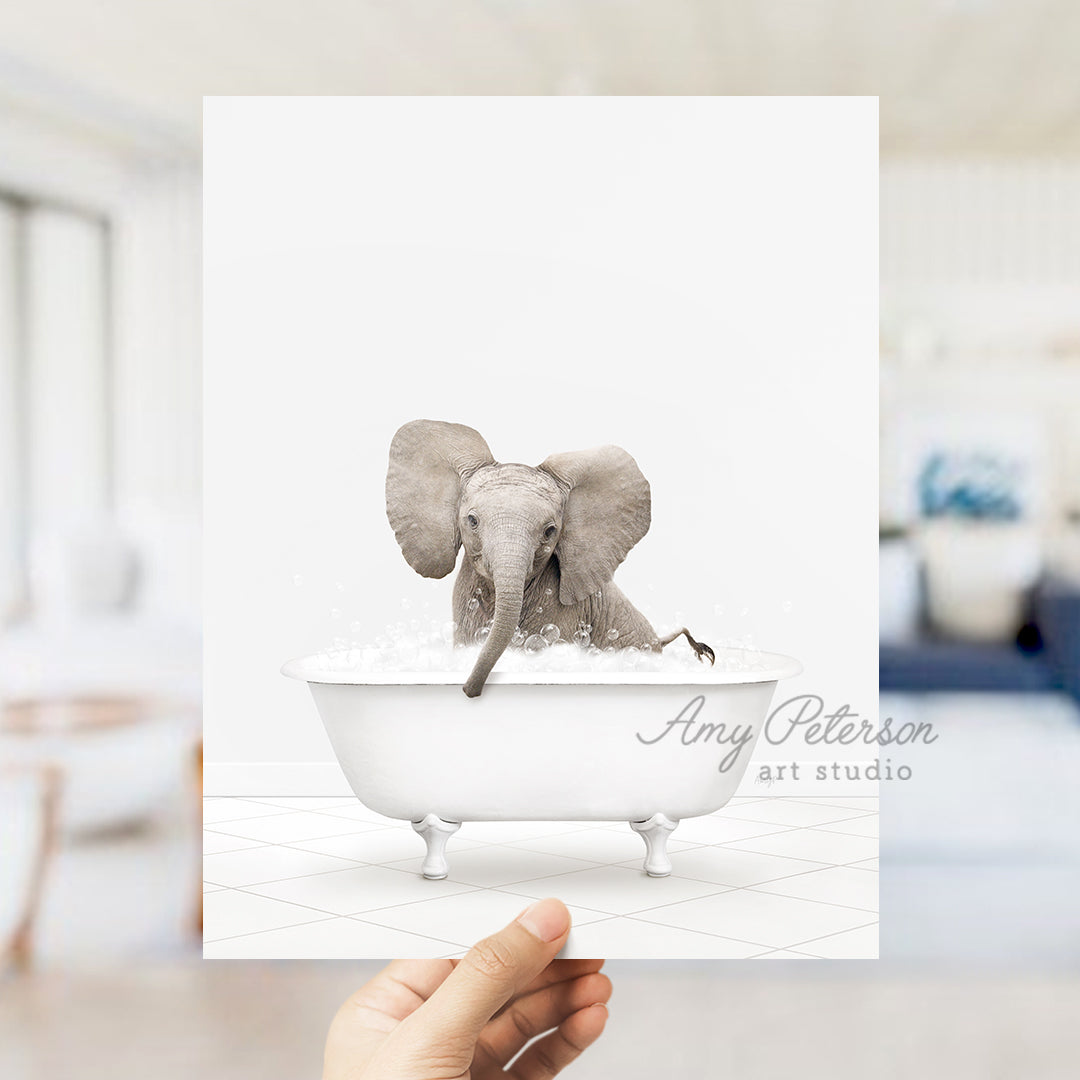 a person holding up a card with an elephant in a bathtub