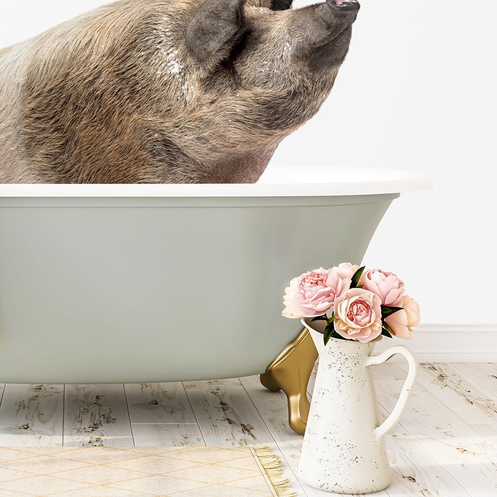 A pig is sitting in a green bathtub, with a vase of pink flowers placed next to it on a white floor.