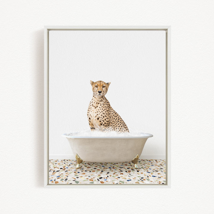 A cheetah sitting in a white bathtub filled with water, looking directly at the camera.