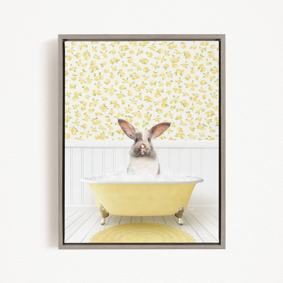 A rabbit sitting in a yellow bathtub filled with water, surrounded by a yellow and white floral pattern on the wall behind it.