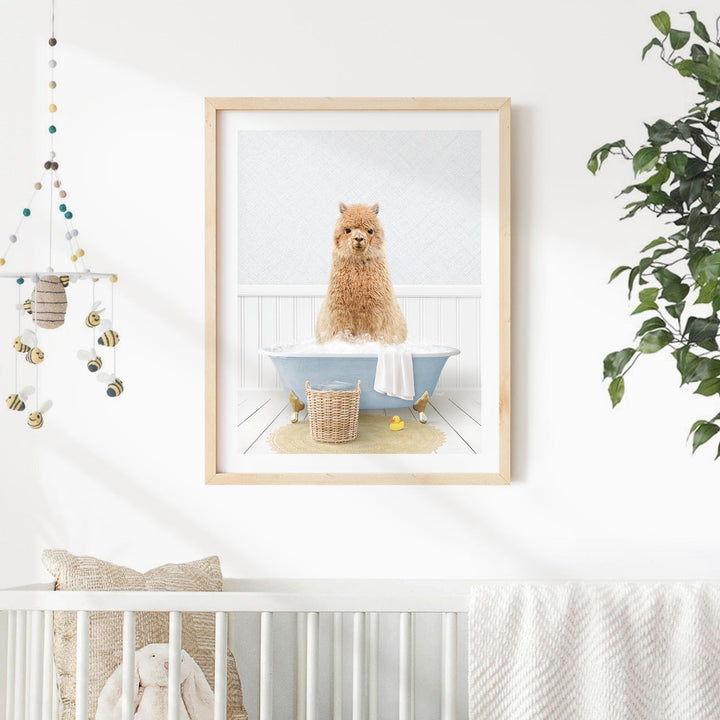 A framed image of a brown dog sitting in a blue bathtub, surrounded by a white towel and yellow rubber duckies, is displayed on a white wall in a nursery setting.
