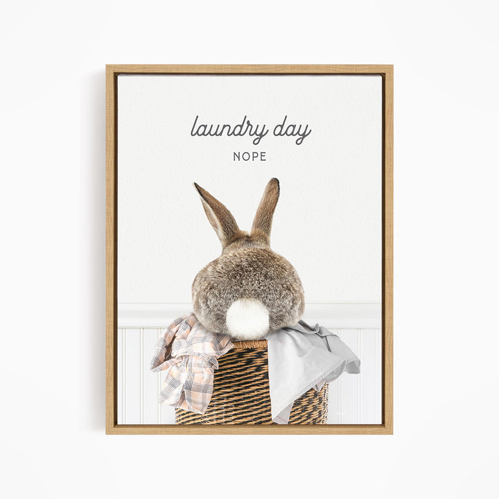 A picture of a rabbit sitting in a laundry basket, with the text "laundry day NOPE" above it.