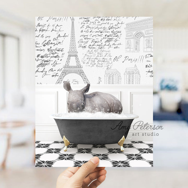 a rhino in a bathtub with the eiffel tower in the background