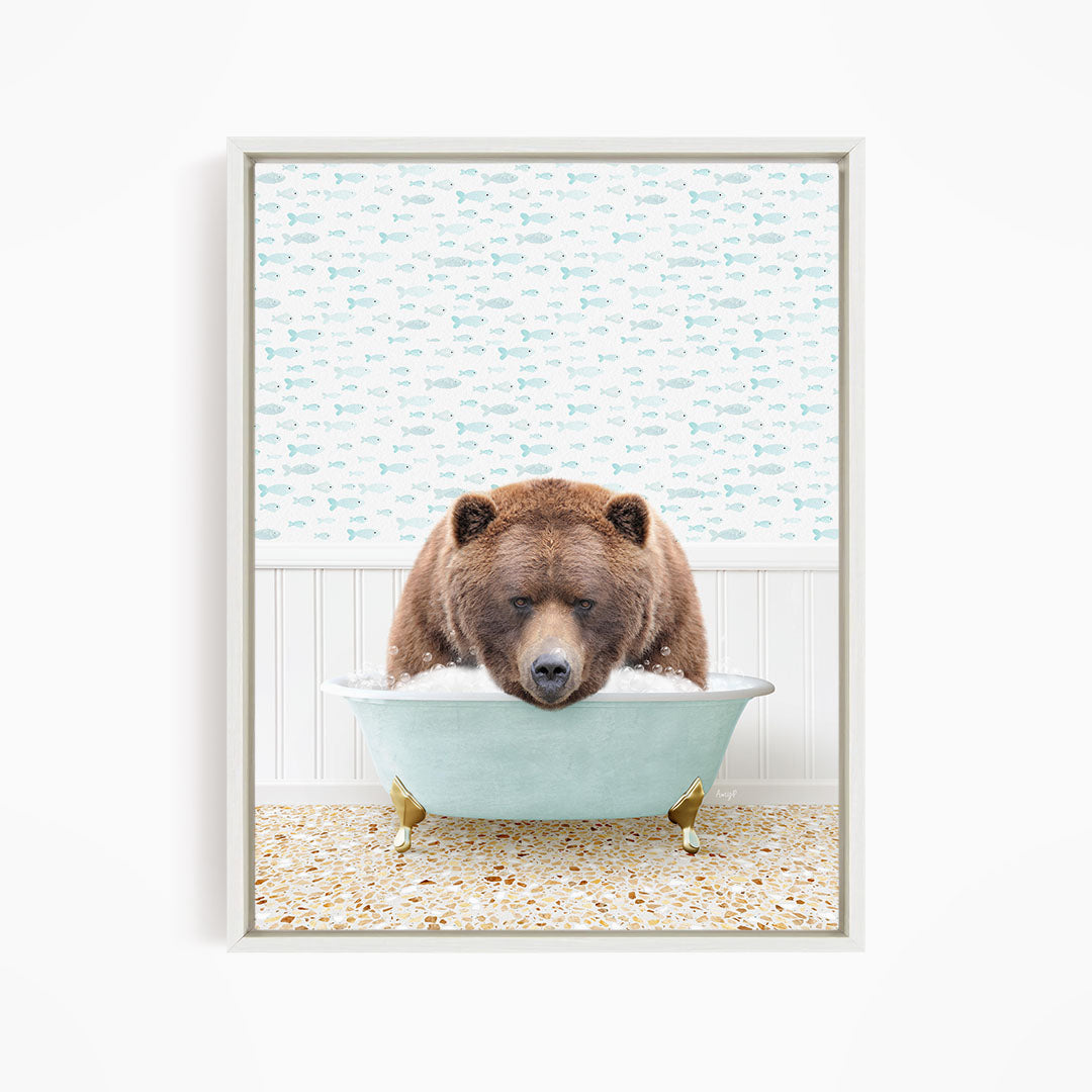 A brown bear is sitting in a light blue bathtub filled with water, surrounded by a pattern of fish.