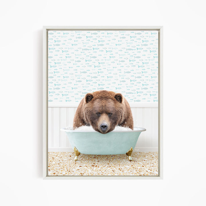 A brown bear is sitting in a light blue bathtub filled with water, surrounded by a pattern of fish.