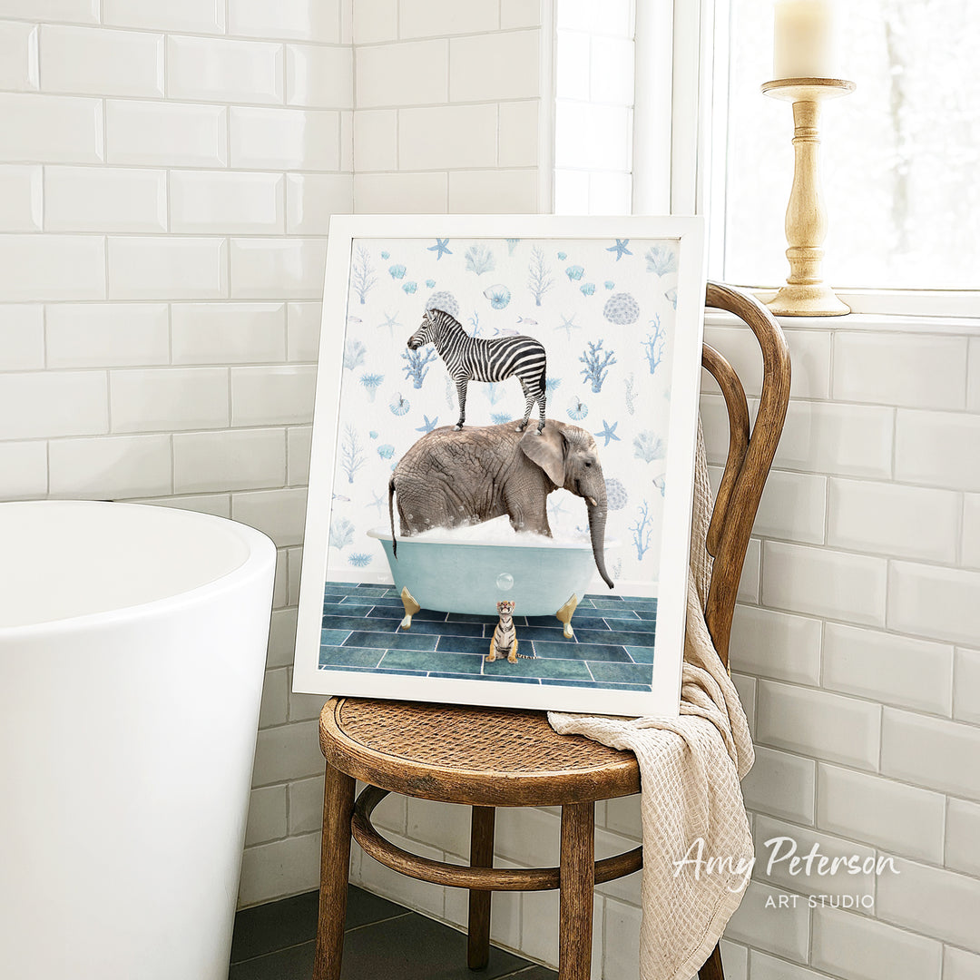 A framed illustration of a zebra standing on an elephant in a bathtub, surrounded by various sea creatures, is displayed on a wooden chair in a bathroom setting.