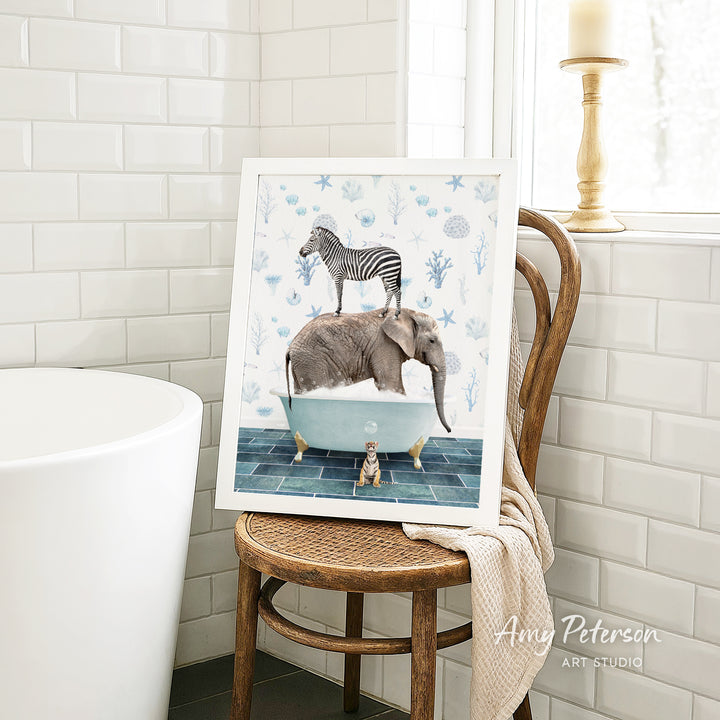 A framed illustration of a zebra standing on an elephant in a bathtub, surrounded by various sea creatures, is displayed on a wooden chair in a bathroom setting.