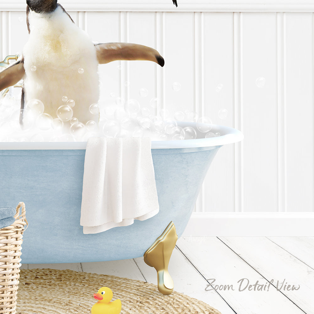A penguin standing in a blue bathtub filled with bubbles, surrounded by a yellow rubber duck and a white towel.