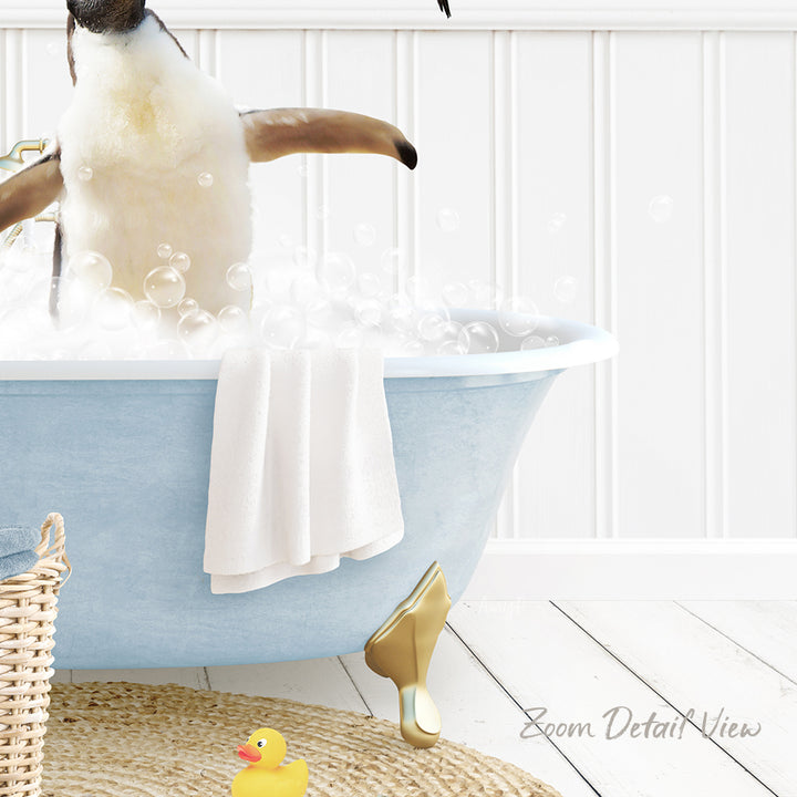 A penguin standing in a blue bathtub filled with bubbles, surrounded by a yellow rubber duck and a white towel.
