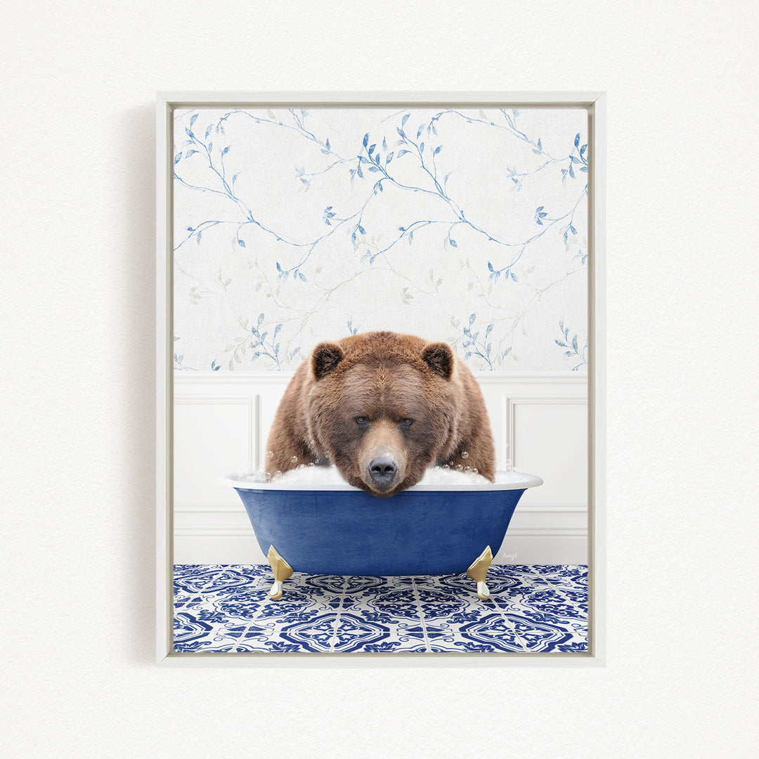 A brown bear is sitting in a blue bathtub, surrounded by a blue and white patterned floor.