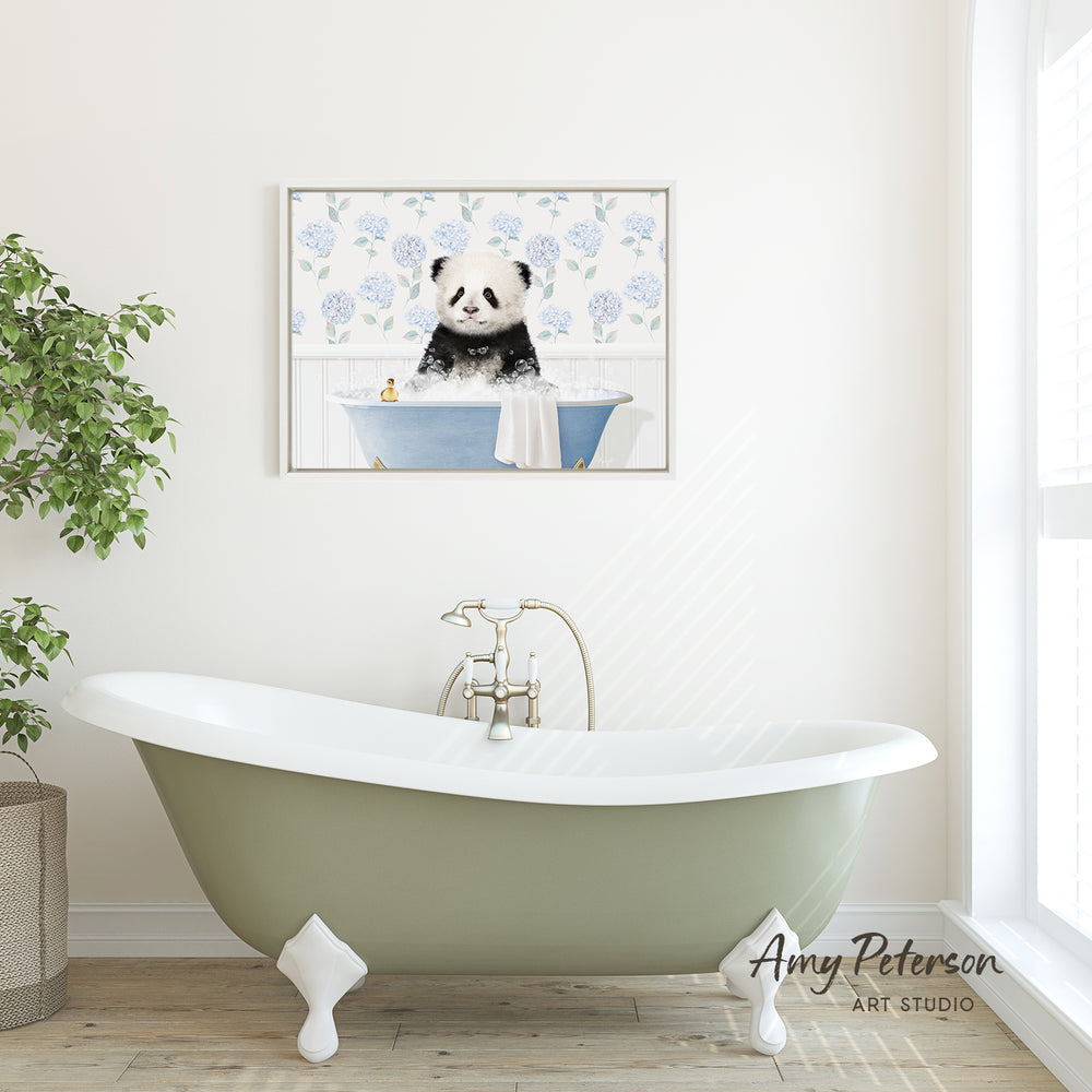 A framed image of a panda sitting in a bathtub is displayed on the wall above a green clawfoot bathtub in a bathroom.