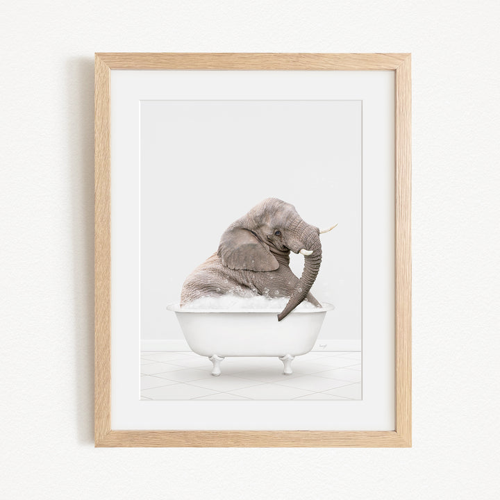 A gray elephant sitting in a white bathtub, with its trunk raised in the air.