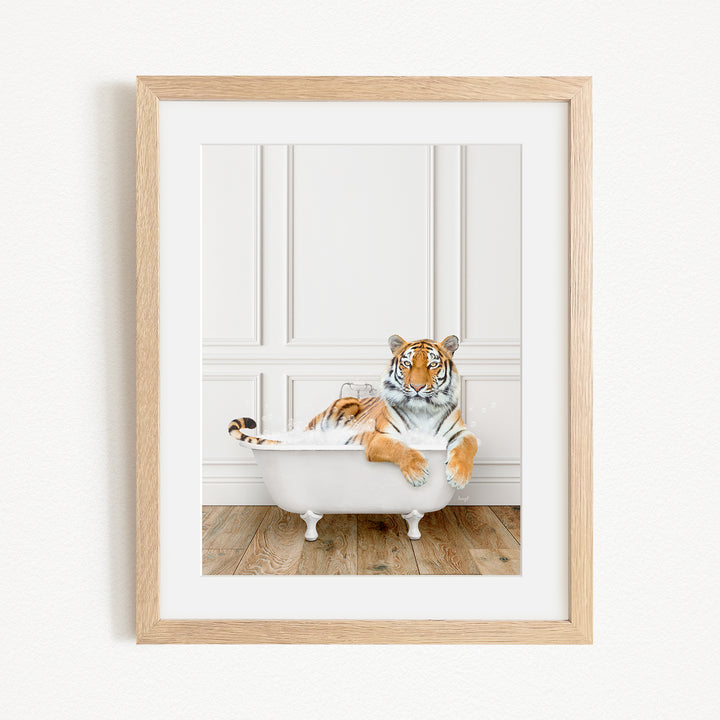 A tiger is sitting in a white bathtub, appearing relaxed and enjoying the bath.