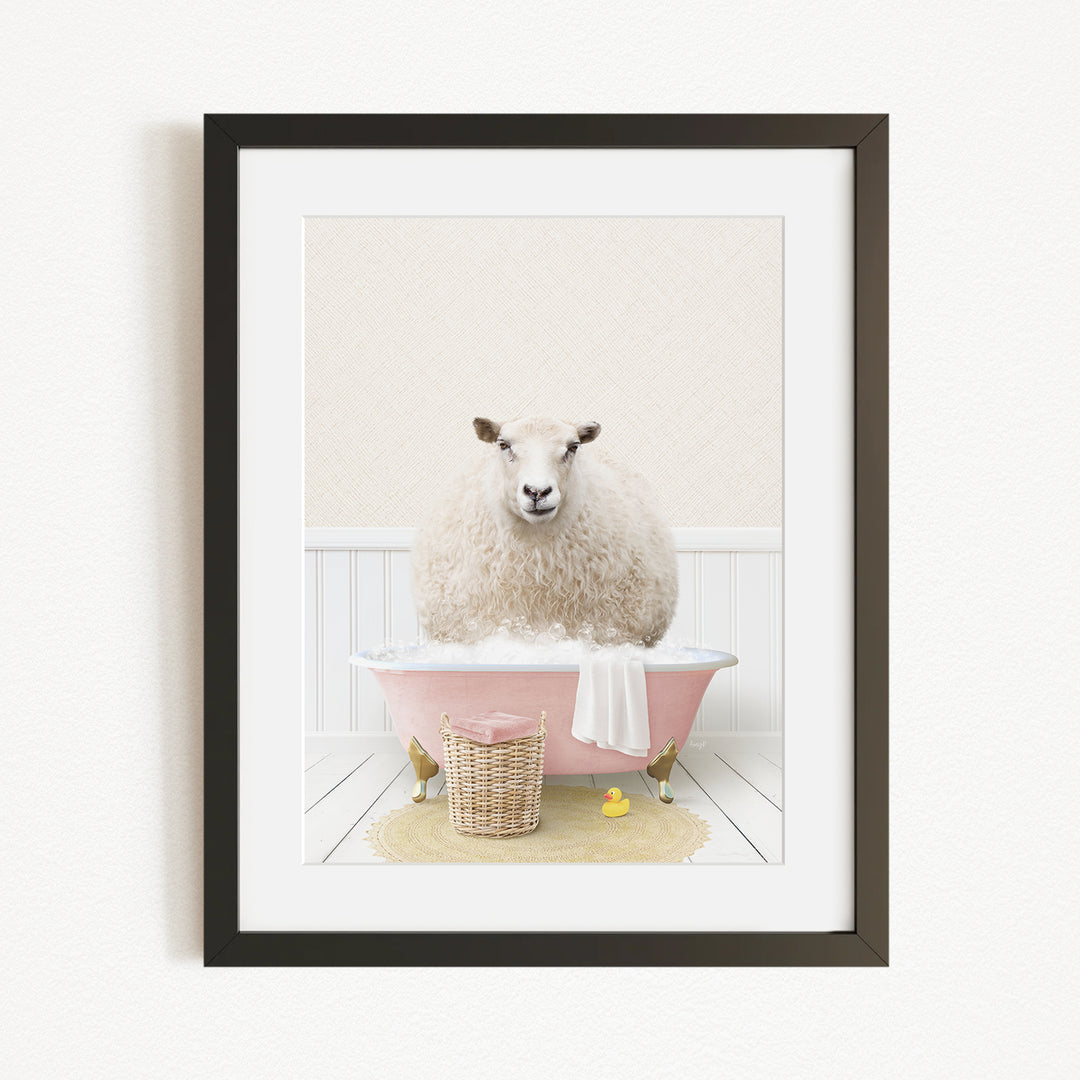 A fluffy white sheep sits in a pink bathtub, surrounded by a yellow bath mat and a basket of rubber ducks.