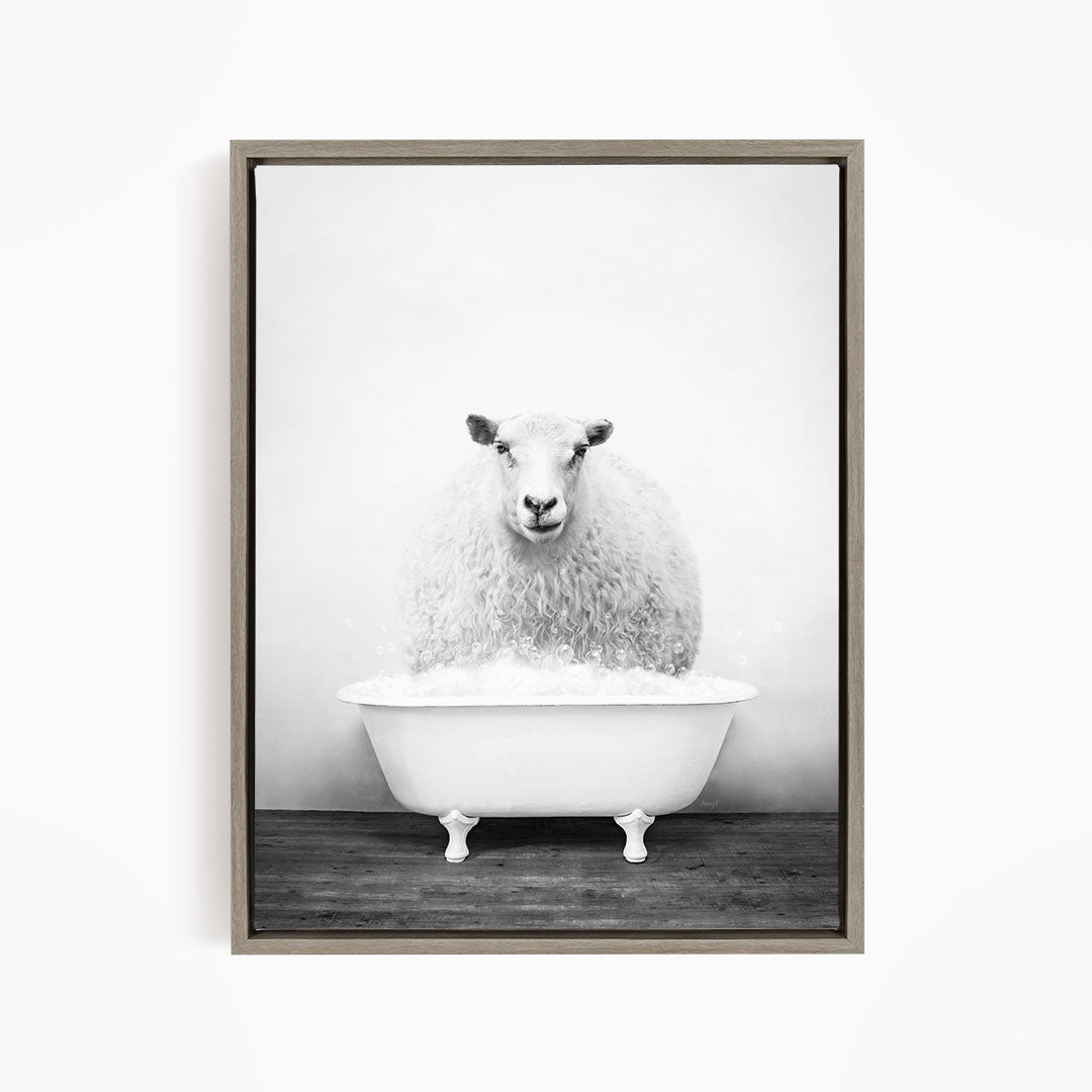 A fluffy white sheep sits in a white bathtub filled with bubbles, creating a whimsical and amusing scene.
