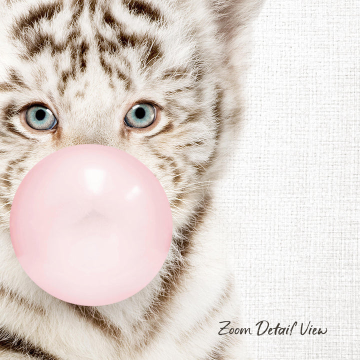 A close-up of a cat's face with its eyes open, looking directly at the camera, and blowing a pink bubble with a bubble gum bubble wand.