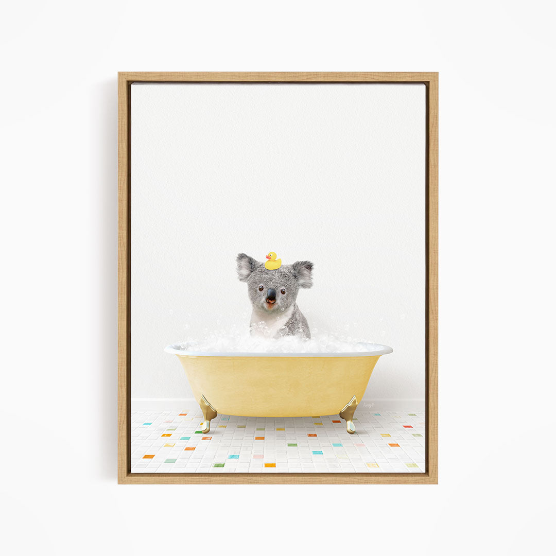 A koala bear sitting in a yellow bathtub filled with bubbles, wearing a yellow rubber duck hat.