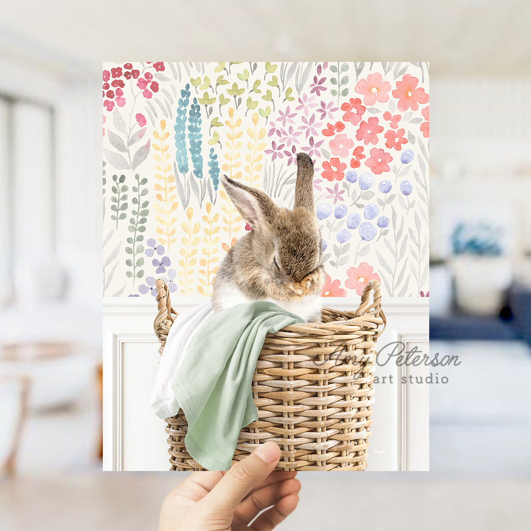 a person holding a card with a picture of a bunny in a basket