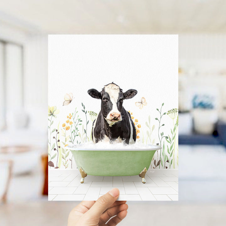 A black and white cow is sitting in a green bathtub filled with water, surrounded by flowers and butterflies.
