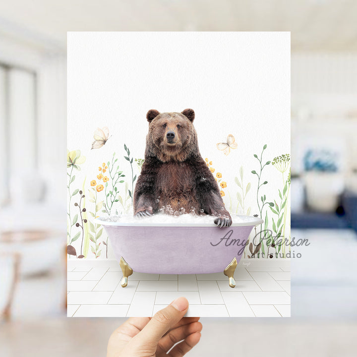 a person holding up a card with a bear in a bathtub