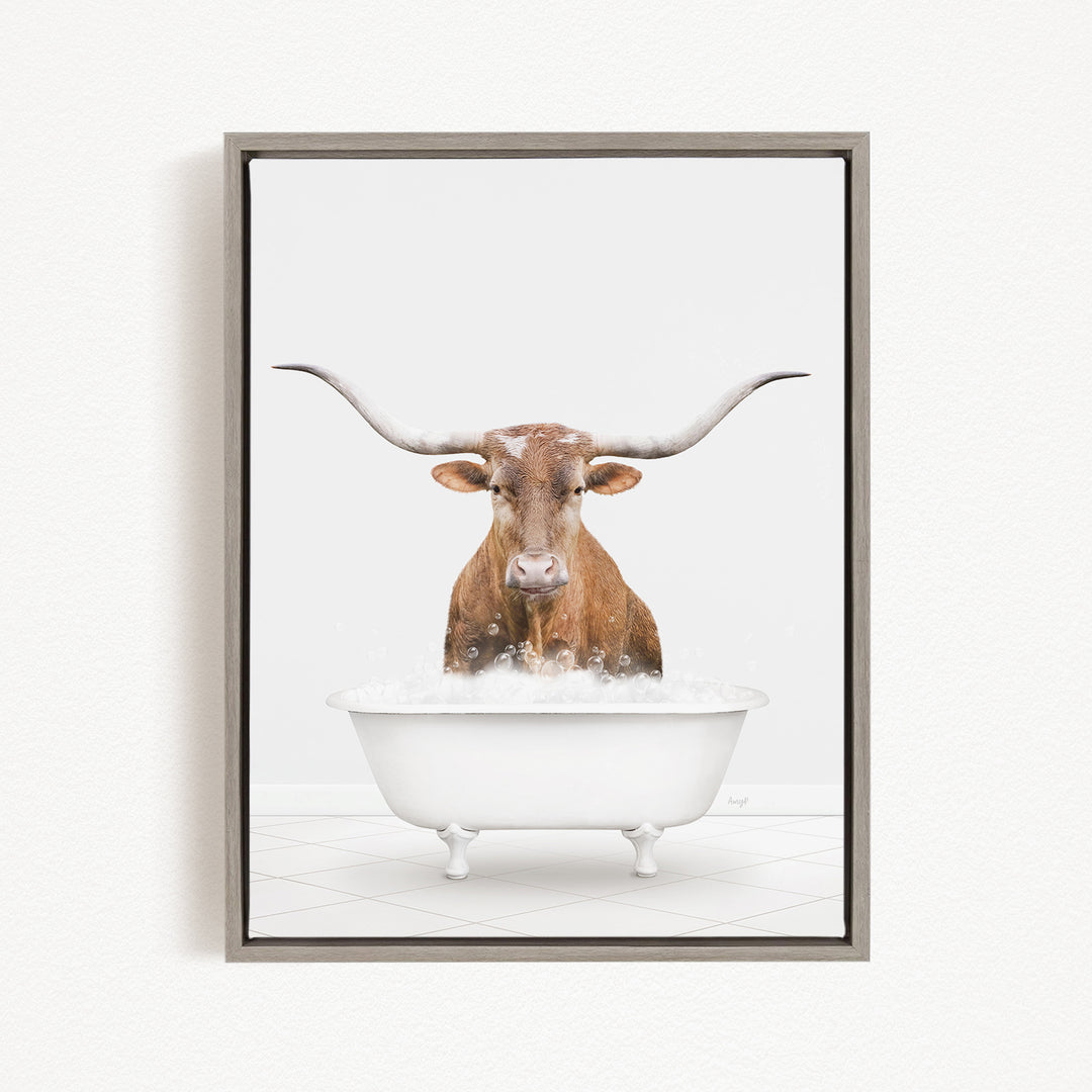 A brown cow with long horns is sitting in a white bathtub filled with water, creating a whimsical and humorous scene.
