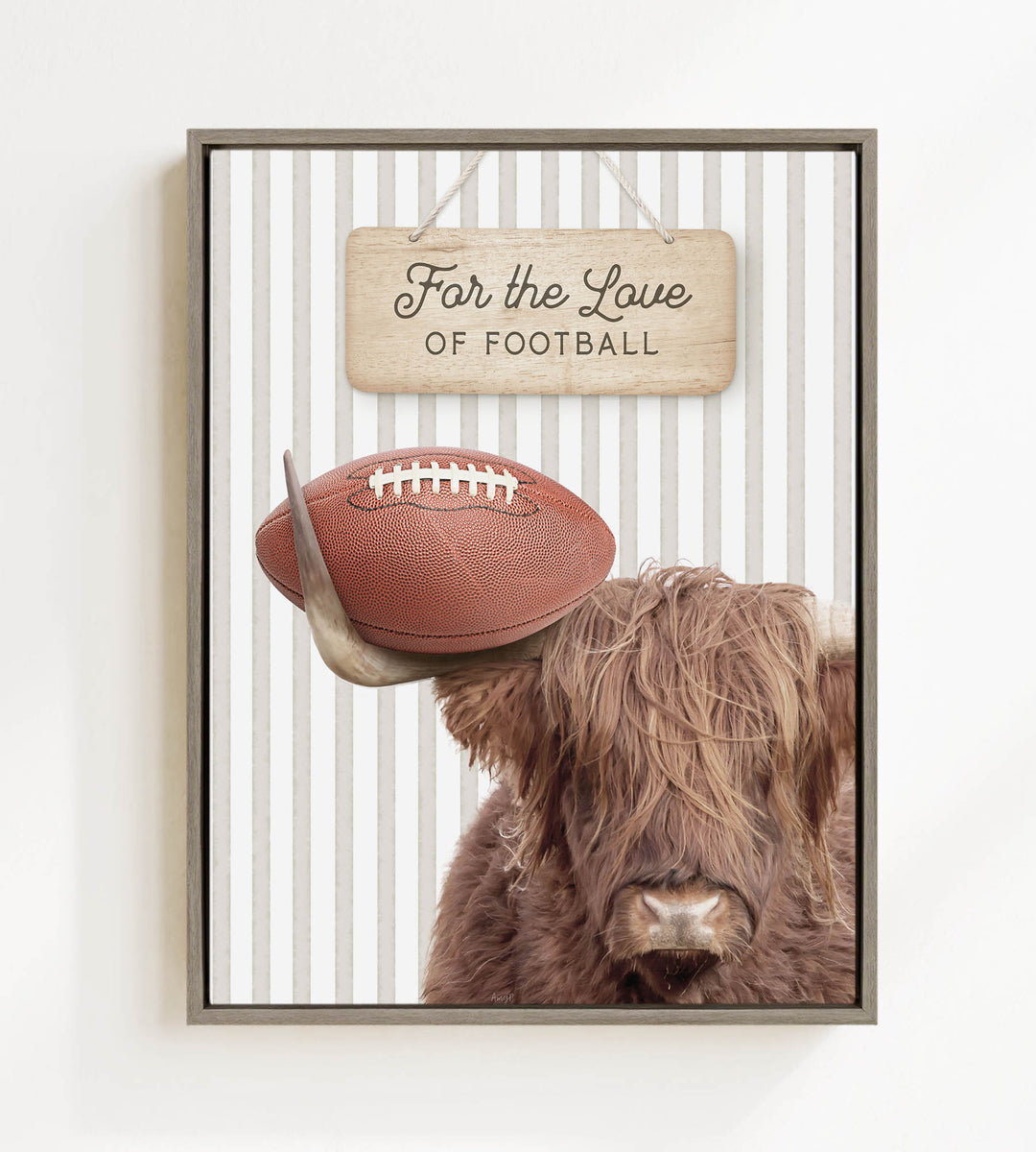 A framed image featuring a Highland cow with a football on its head, accompanied by a wooden sign that reads "For the Love of Football".