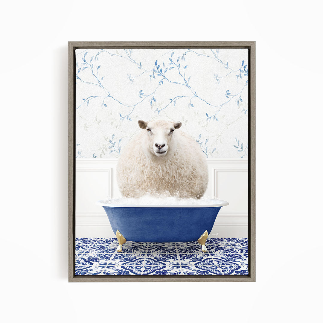 A fluffy white sheep sits in a blue bathtub, surrounded by a blue and white patterned floor.