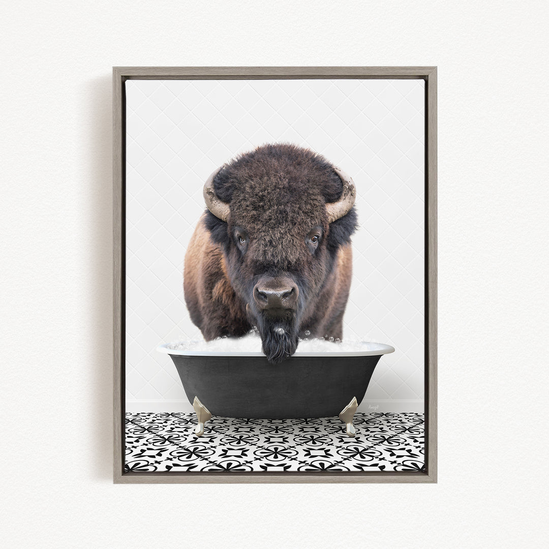A large, furry bison with large horns is standing in a black bathtub filled with water, creating a whimsical and playful scene.