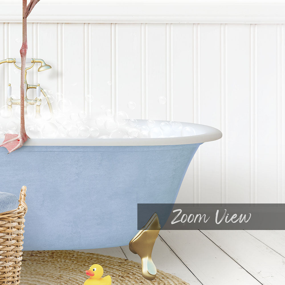 A blue claw-foot bathtub filled with bubbles, with a yellow rubber duck and a basket of bath toys nearby.