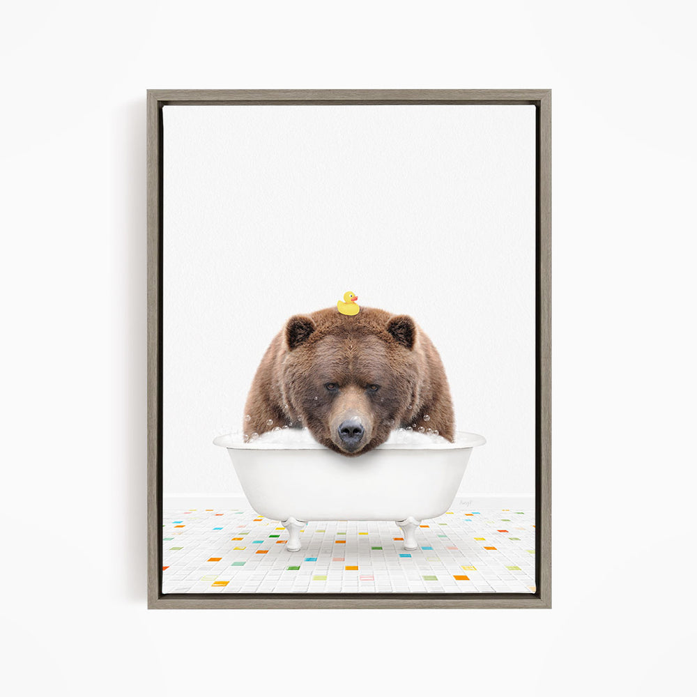 A brown bear is sitting in a white bathtub, with a yellow rubber duck perched on its head.