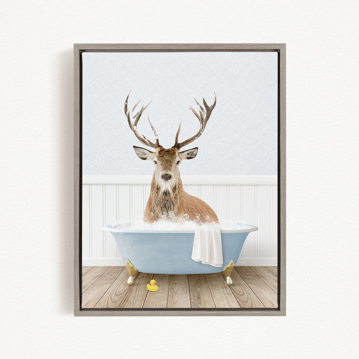 A deer with antlers is sitting in a bathtub filled with water, surrounded by rubber ducks.