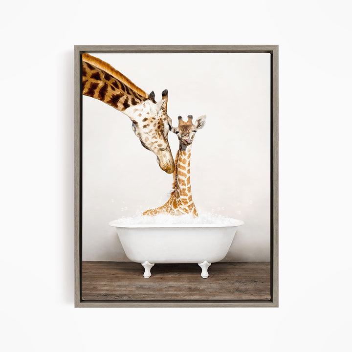 A mother giraffe and her baby giraffe are sitting together in a white bathtub filled with water, with the mother giraffe's head dipping into the water to give her baby a bath.
