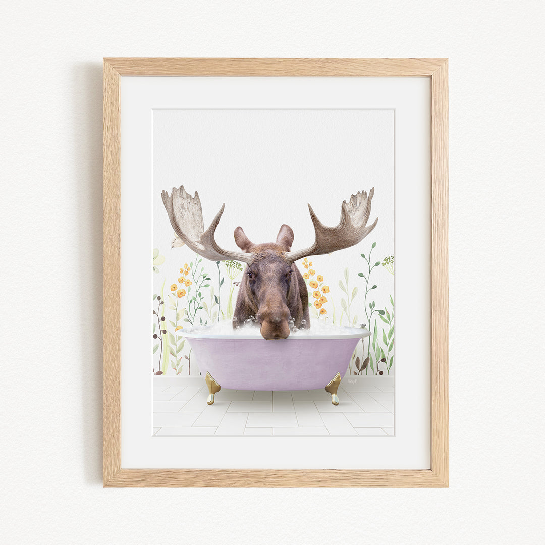 A moose with large antlers is sitting in a purple bathtub, surrounded by flowers and plants.