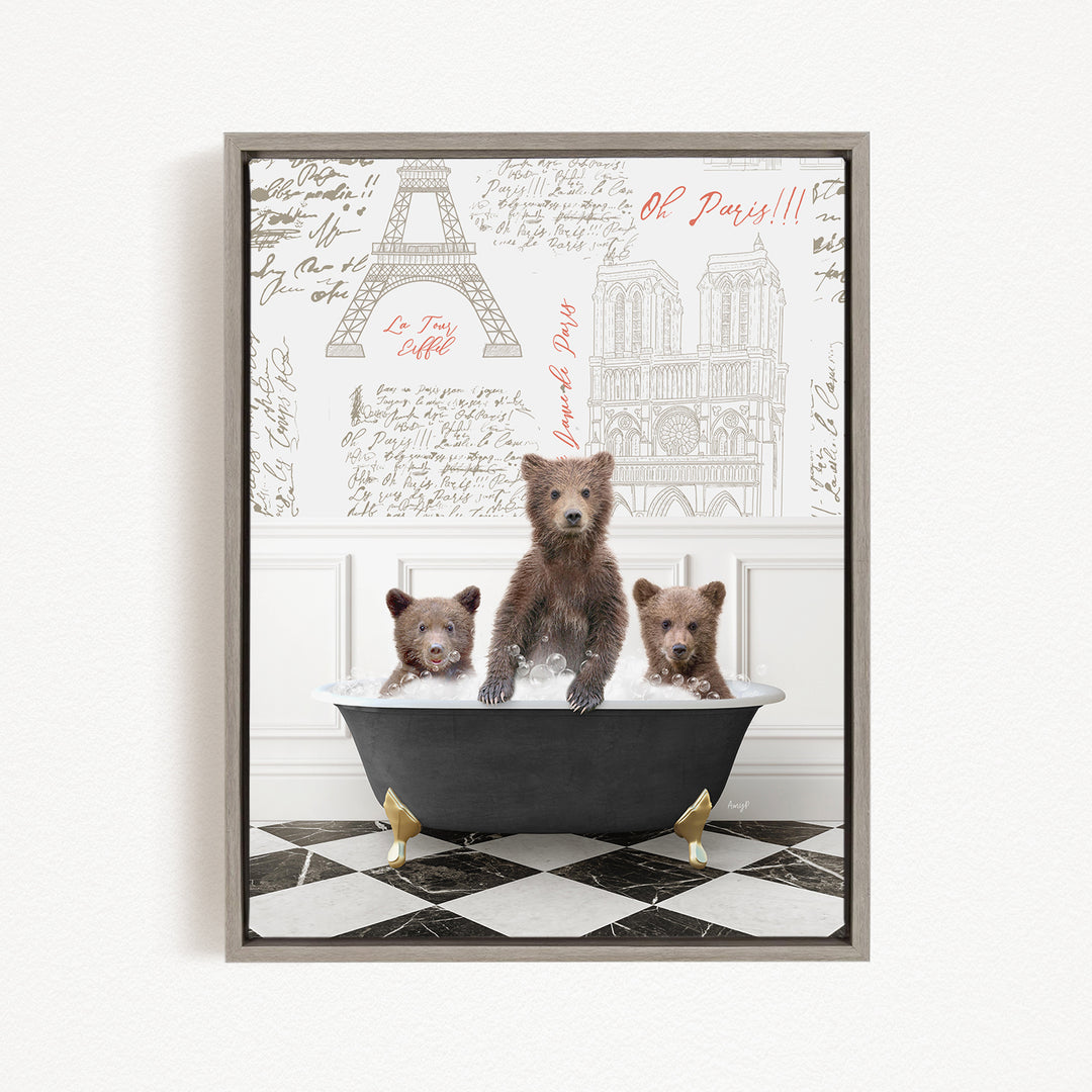A framed image depicting three bears sitting in a bathtub, with a Paris-themed background featuring the Eiffel Tower and other Parisian landmarks.