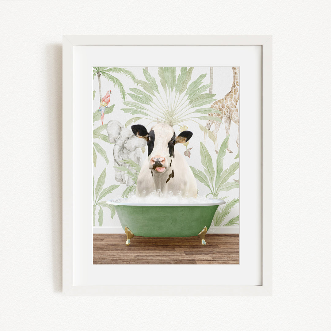A framed image depicting a cow sitting in a green bathtub, surrounded by tropical foliage and animals.