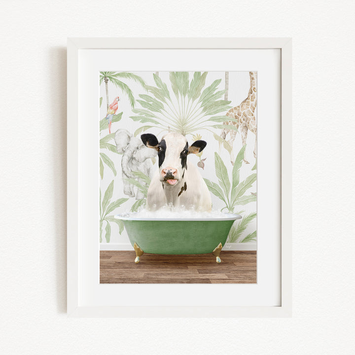 A framed image depicting a cow sitting in a green bathtub, surrounded by tropical foliage and animals.