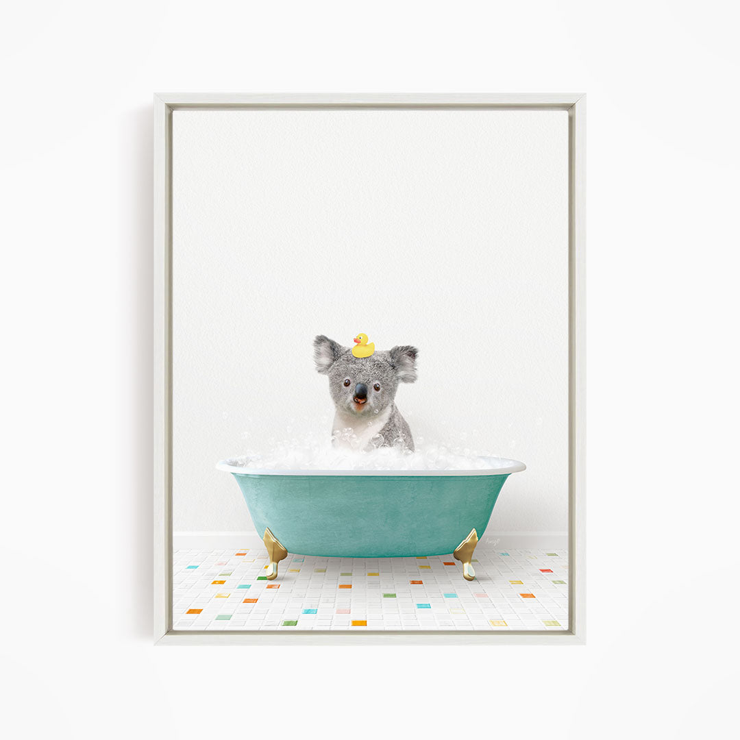A koala bear sitting in a blue bathtub filled with bubbles, wearing a yellow rubber duck hat.