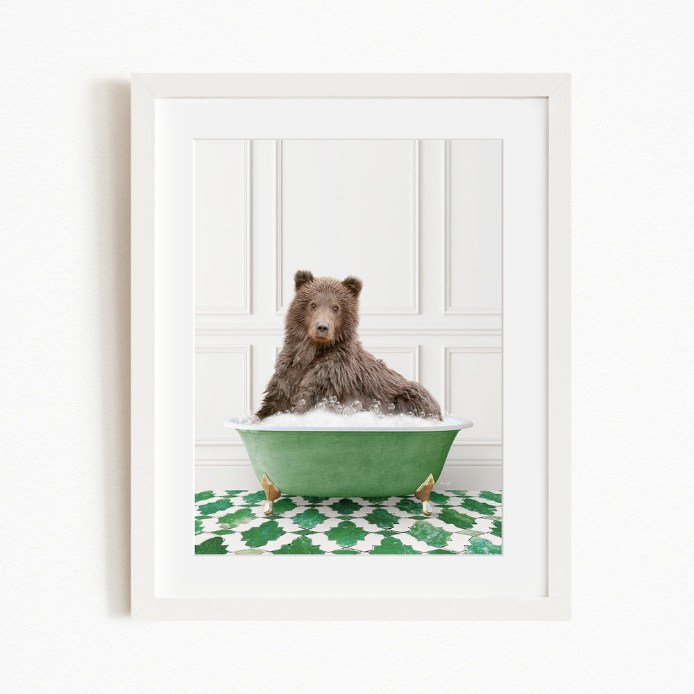 A brown bear sitting in a green bathtub filled with water, surrounded by a green and white patterned rug.