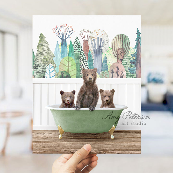 a person holding up a card with three bears in a bathtub