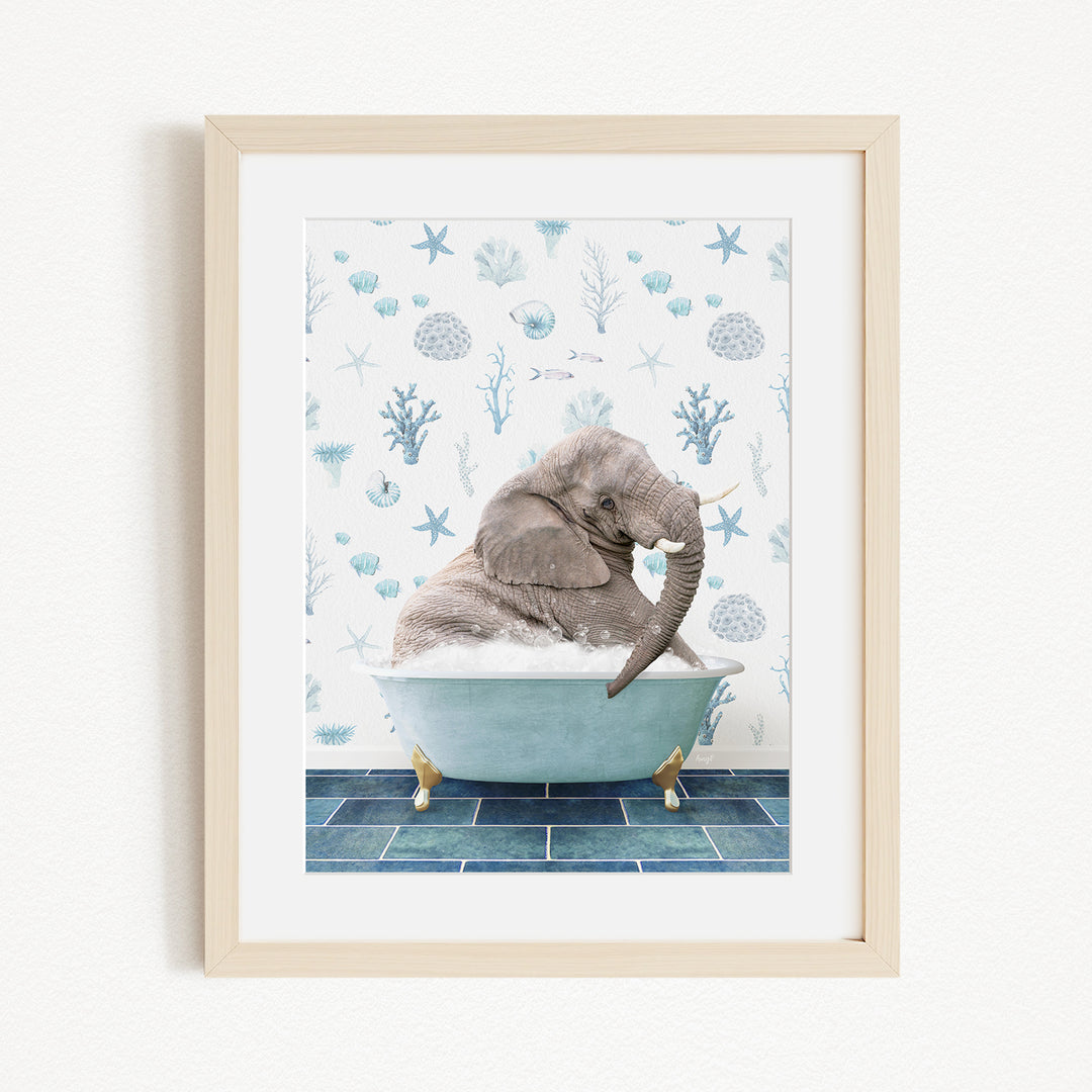 A gray elephant is sitting in a blue bathtub filled with bubbles, surrounded by a blue and white ocean-themed background.