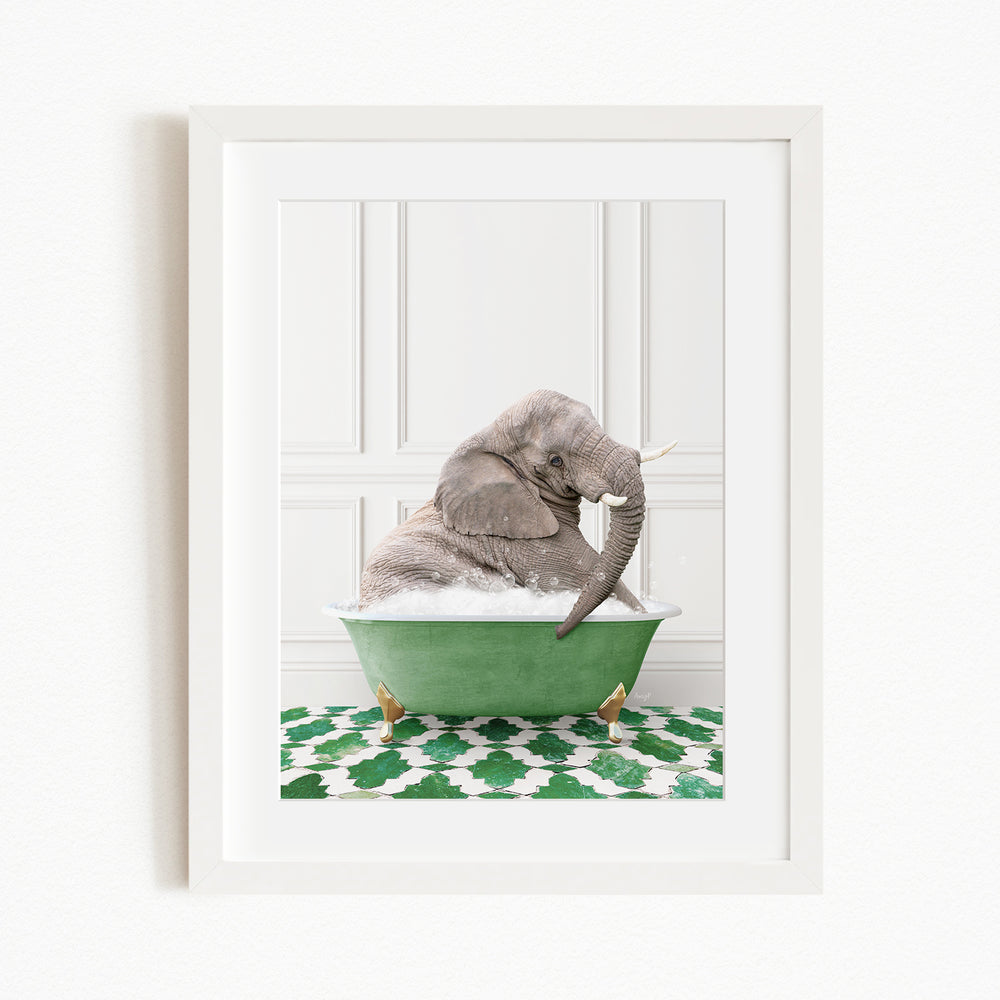 A gray elephant is sitting in a green bathtub filled with water, surrounded by a green and white patterned rug.