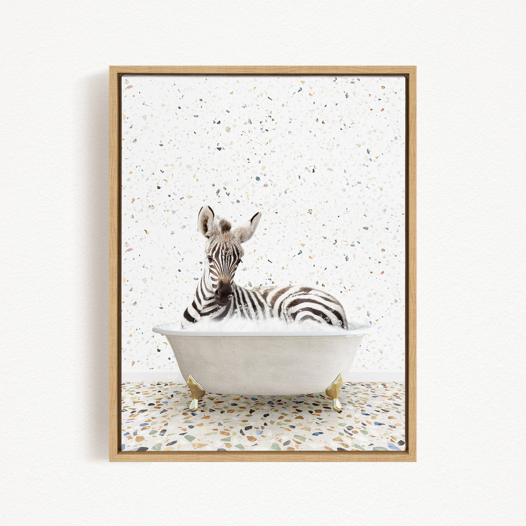 A zebra is sitting in a white bathtub, surrounded by a speckled background.