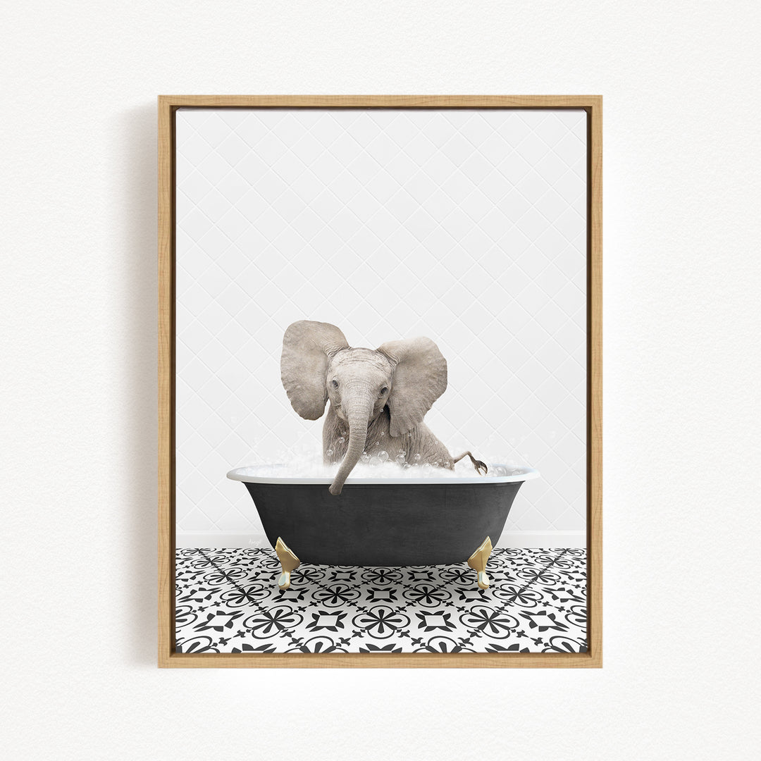 A gray elephant is sitting in a black bathtub filled with water, surrounded by a black and white patterned floor.