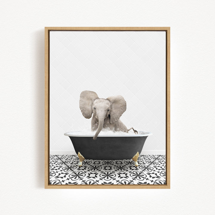 A gray elephant is sitting in a black bathtub filled with water, surrounded by a black and white patterned floor.