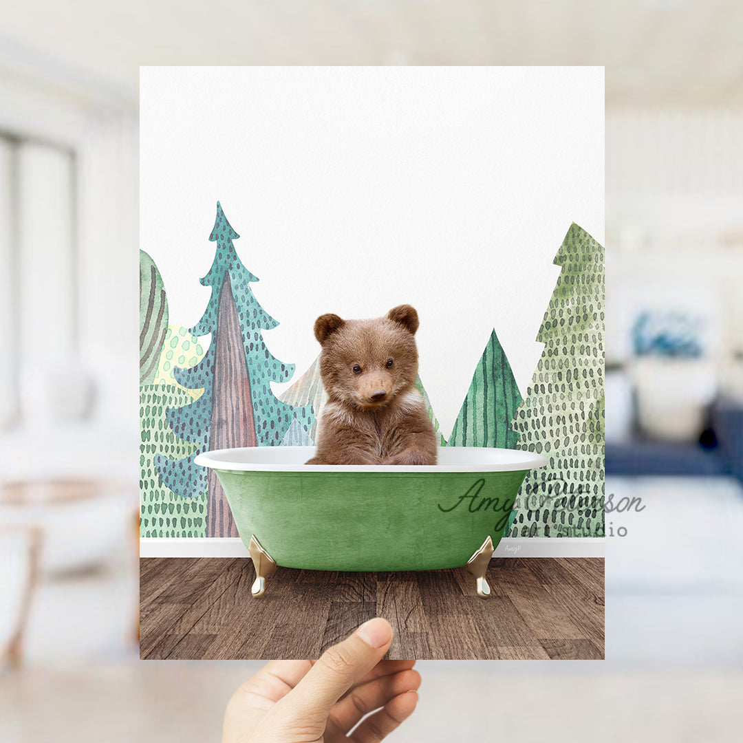 a person holding a polaroid with a picture of a bear in a bathtub