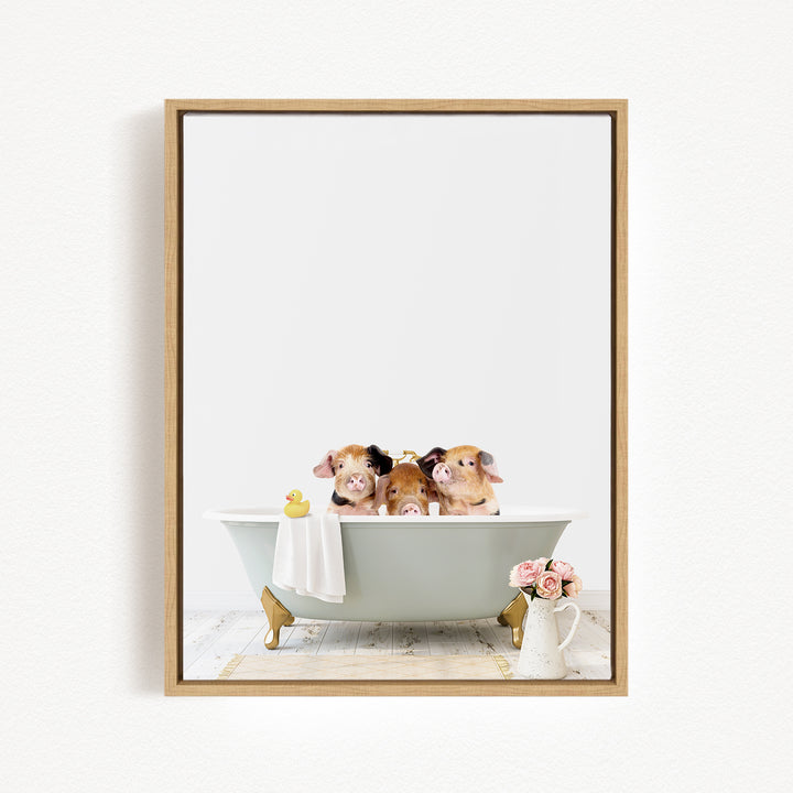 A framed image depicting three adorable pigs sitting in a bathtub, with a yellow rubber duck floating on the water.