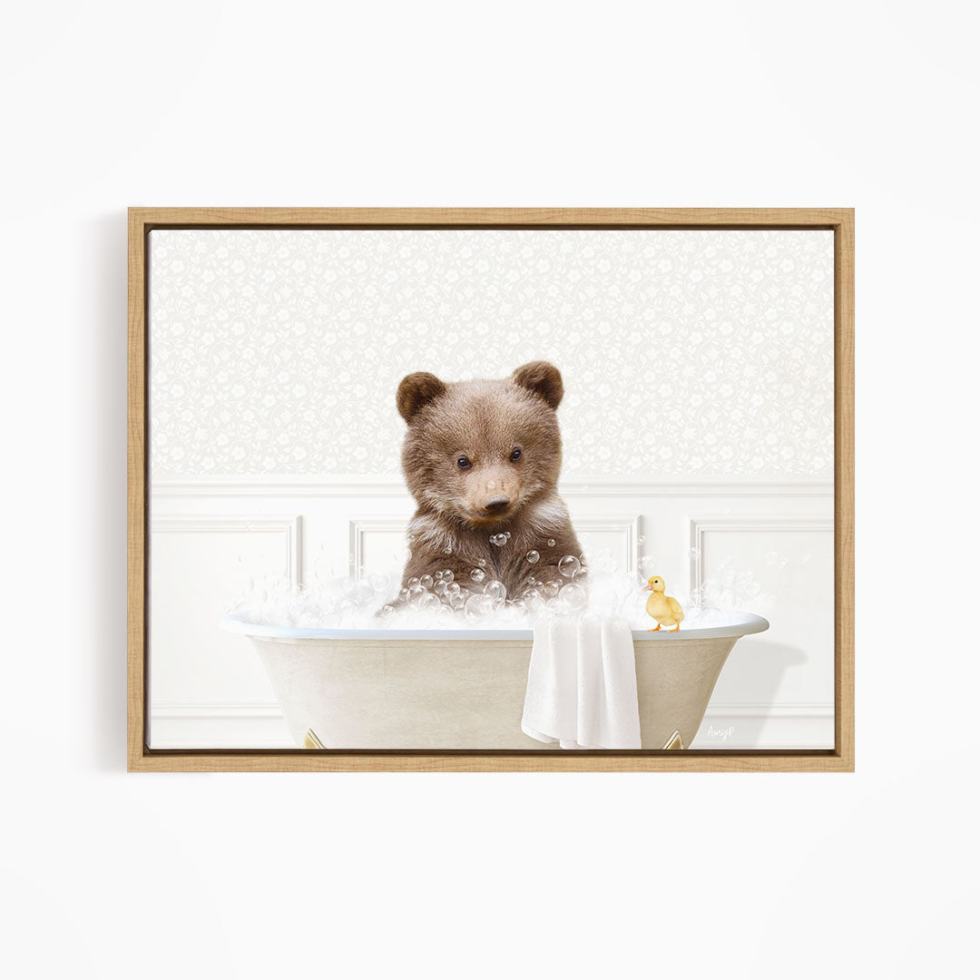 A brown bear sitting in a bathtub filled with bubbles, with a yellow duck nearby.