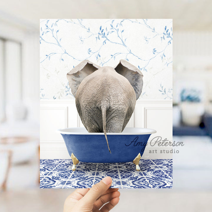 a person holding up a card with an elephant in a bathtub