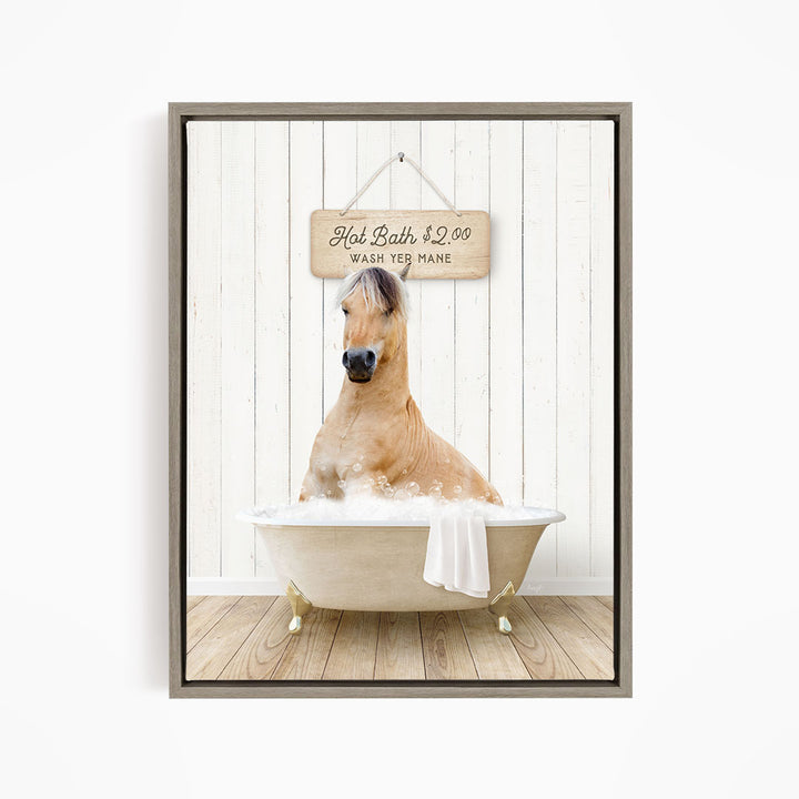A light brown horse is sitting in a white bathtub filled with water, with a wooden sign above it that reads "Hot Bath $2.00 WASH YE MANE".